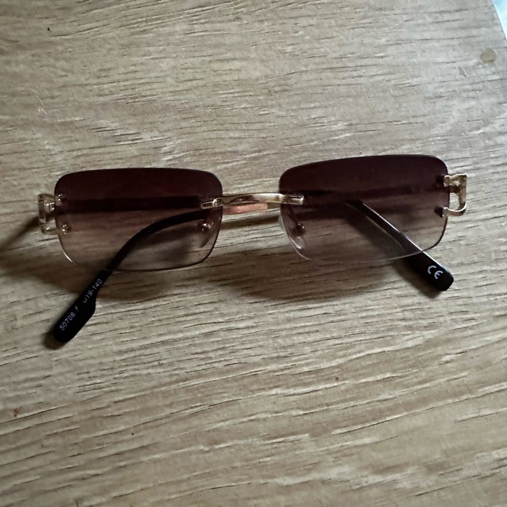 Thin tinted rimless y2k gold and brown sunglasses